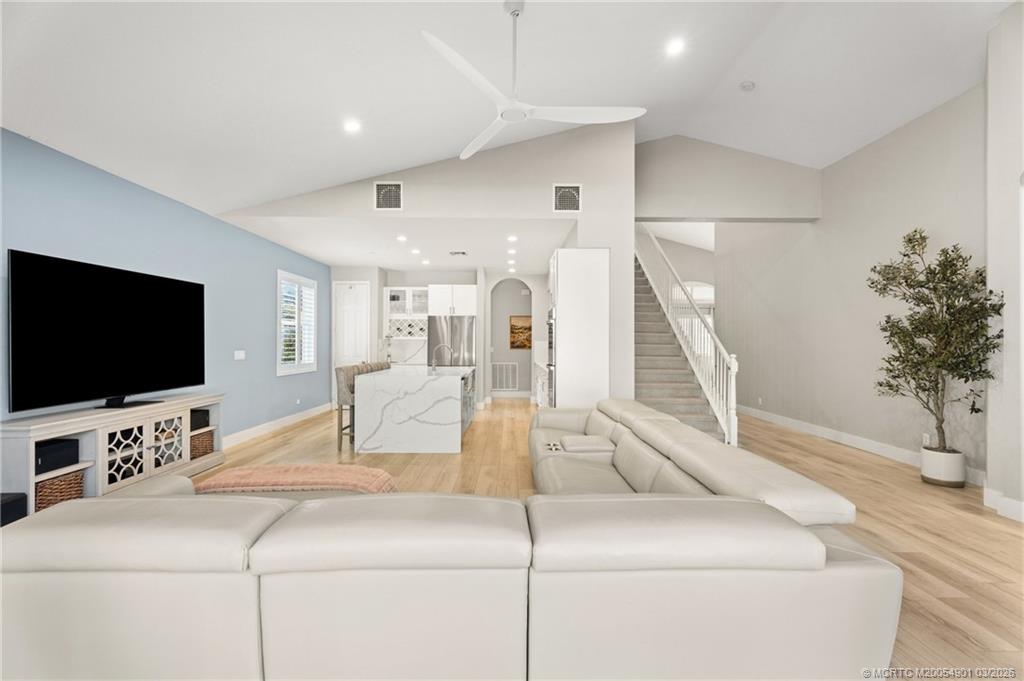 2973 Southwest Porpoise Circle Stuart, FL 34997 - Photo 36 of 47 a living room with furniture and a flat screen tv