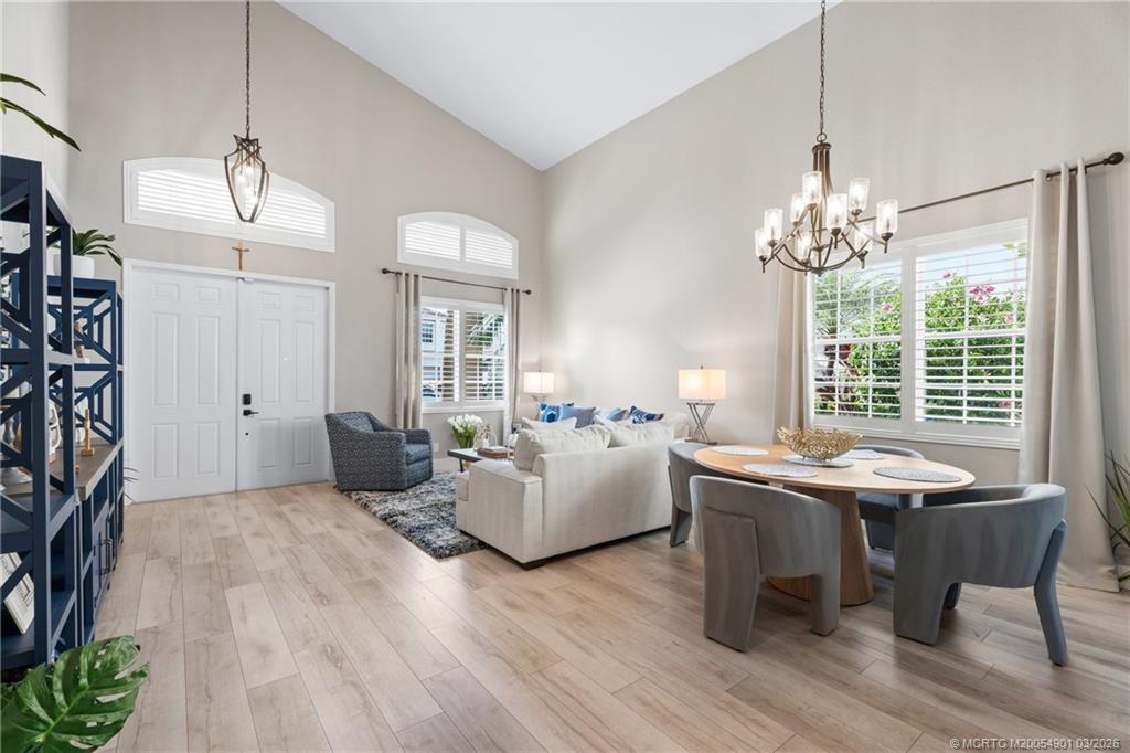 2973 Southwest Porpoise Circle Stuart, FL 34997 - Photo 37 of 47 a living room with furniture and a chandelier