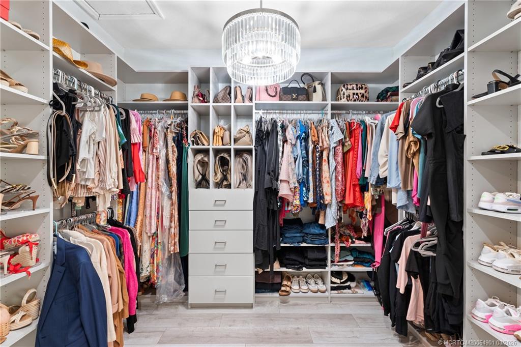 2973 Southwest Porpoise Circle Stuart, FL 34997 - Photo 38 of 47 a view of walk in closet with clothes
