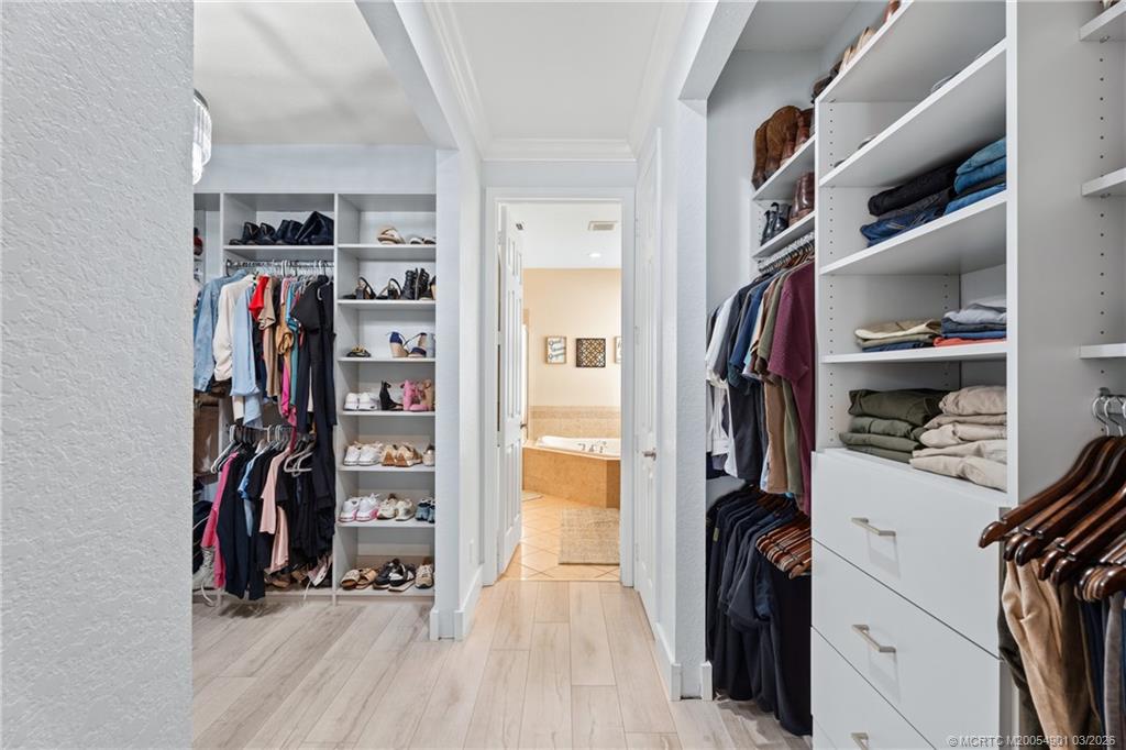 2973 Southwest Porpoise Circle Stuart, FL 34997 - Photo 39 of 47 a view of walk in closet with clothes and shoes