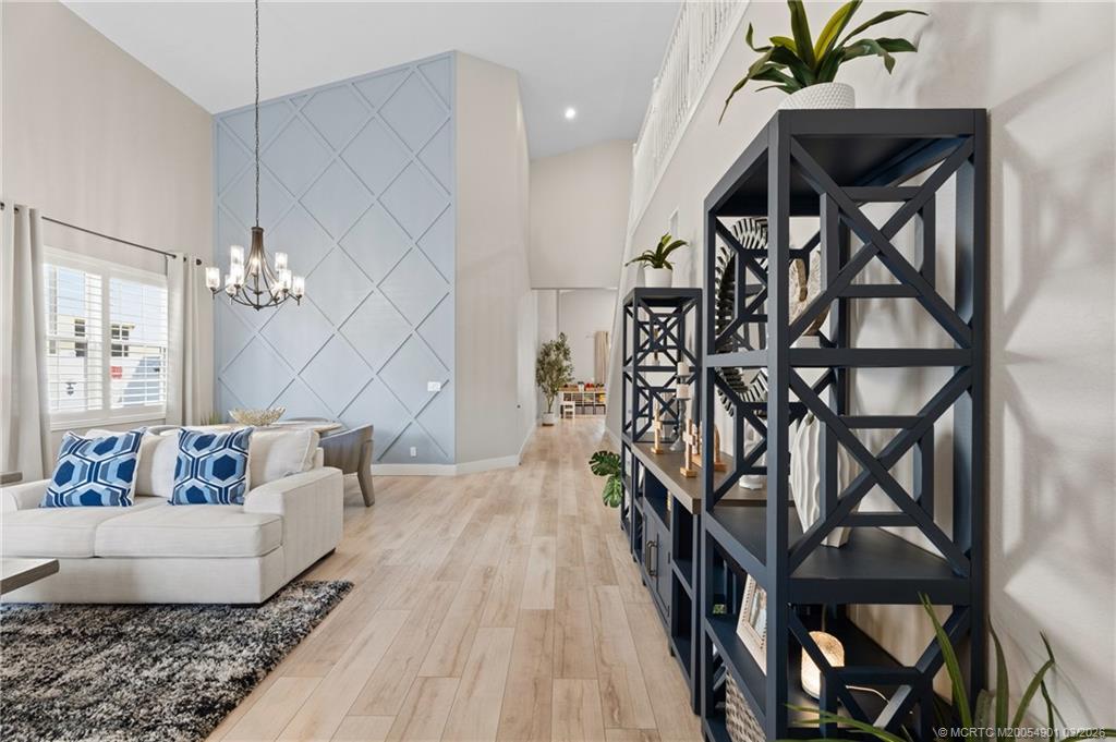 2973 Southwest Porpoise Circle Stuart, FL 34997 - Photo 4 of 47 a living room with furniture and wooden floor