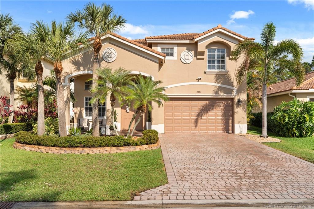 2973 Southwest Porpoise Circle Stuart, FL 34997 - Photo 43 of 47 a view of a white house with large windows