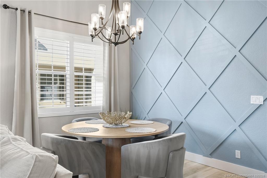 2973 Southwest Porpoise Circle Stuart, FL 34997 - Photo 6 of 47 a dining room with a table and chairs