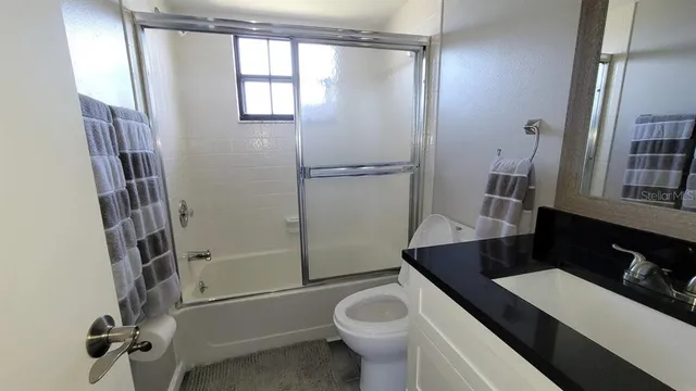 a bed sitting in a bedroom and painting on the wall