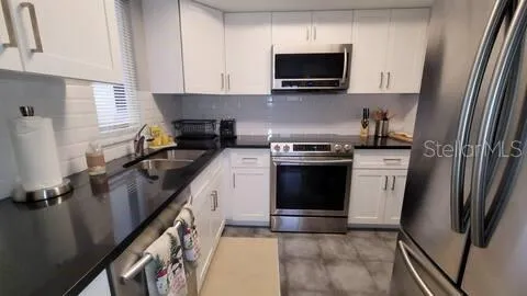 a kitchen with a sink stove and refrigerator