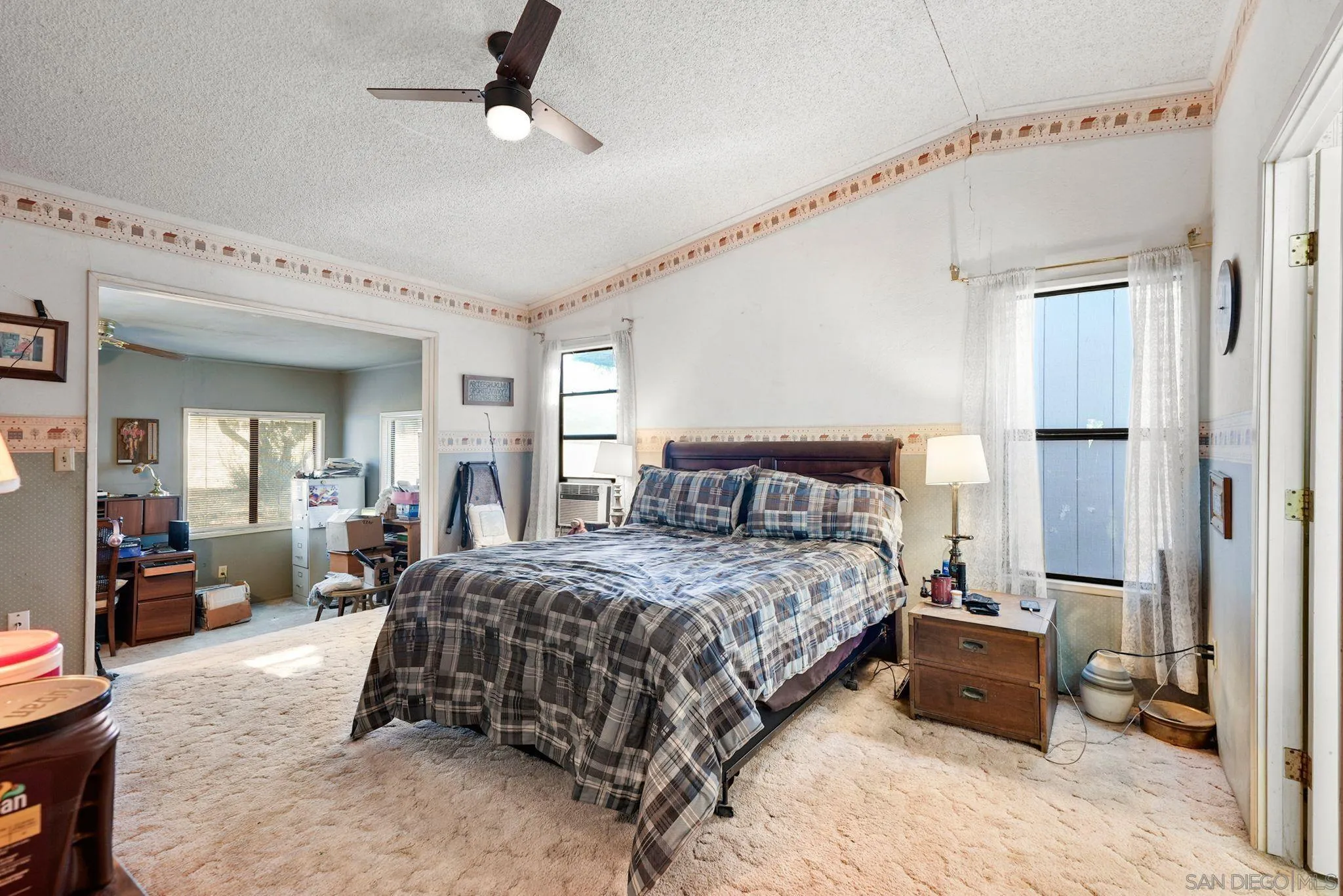 1070 Harris Ranch Road Potrero, CA 91963 - Photo 20 of 58 a bedroom with a bed couch and a window