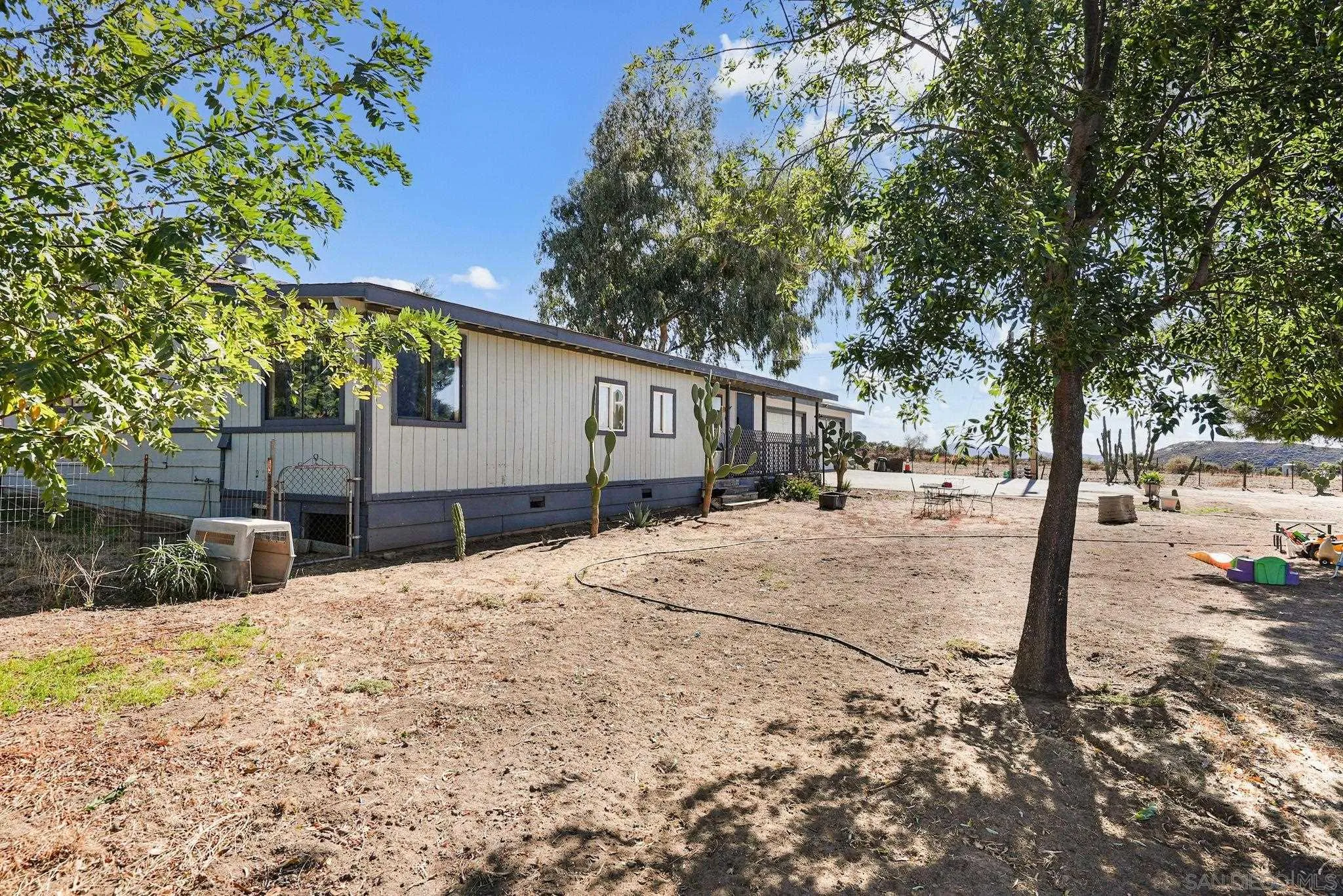 1070 Harris Ranch Road Potrero, CA 91963 - Photo 7 of 58 a street view with a large tree
