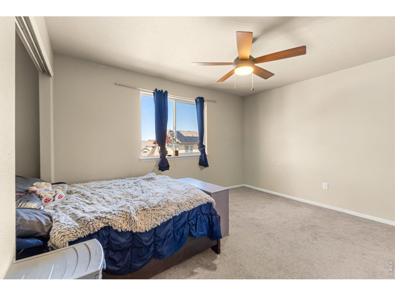 8847 16th St Road Greeley, CO 80634 - Photo 24 of 38 a bedroom with a bed and a chandelier