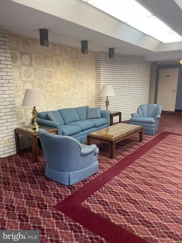 a living room with furniture and a rug