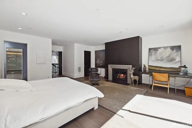 a bedroom with a bed and a fireplace