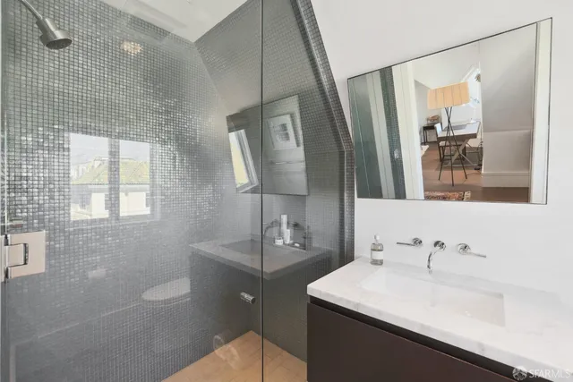 a bathroom with a sink toilet double vanity and tub