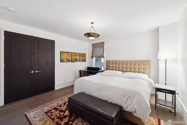 a bedroom with a bed and a dresser