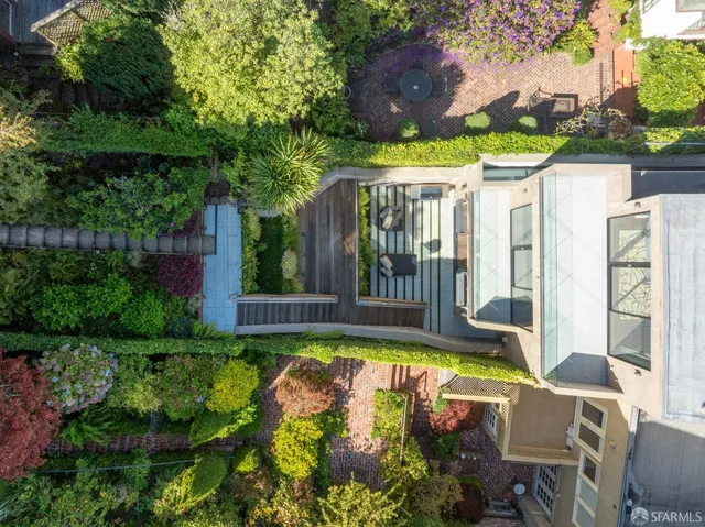 an aerial view of a house with a garden