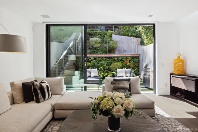 a living room with furniture fireplace and a large window