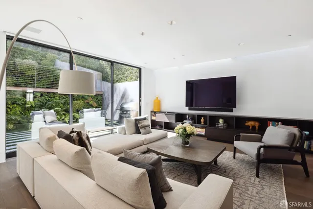 a living room with furniture and a lamp