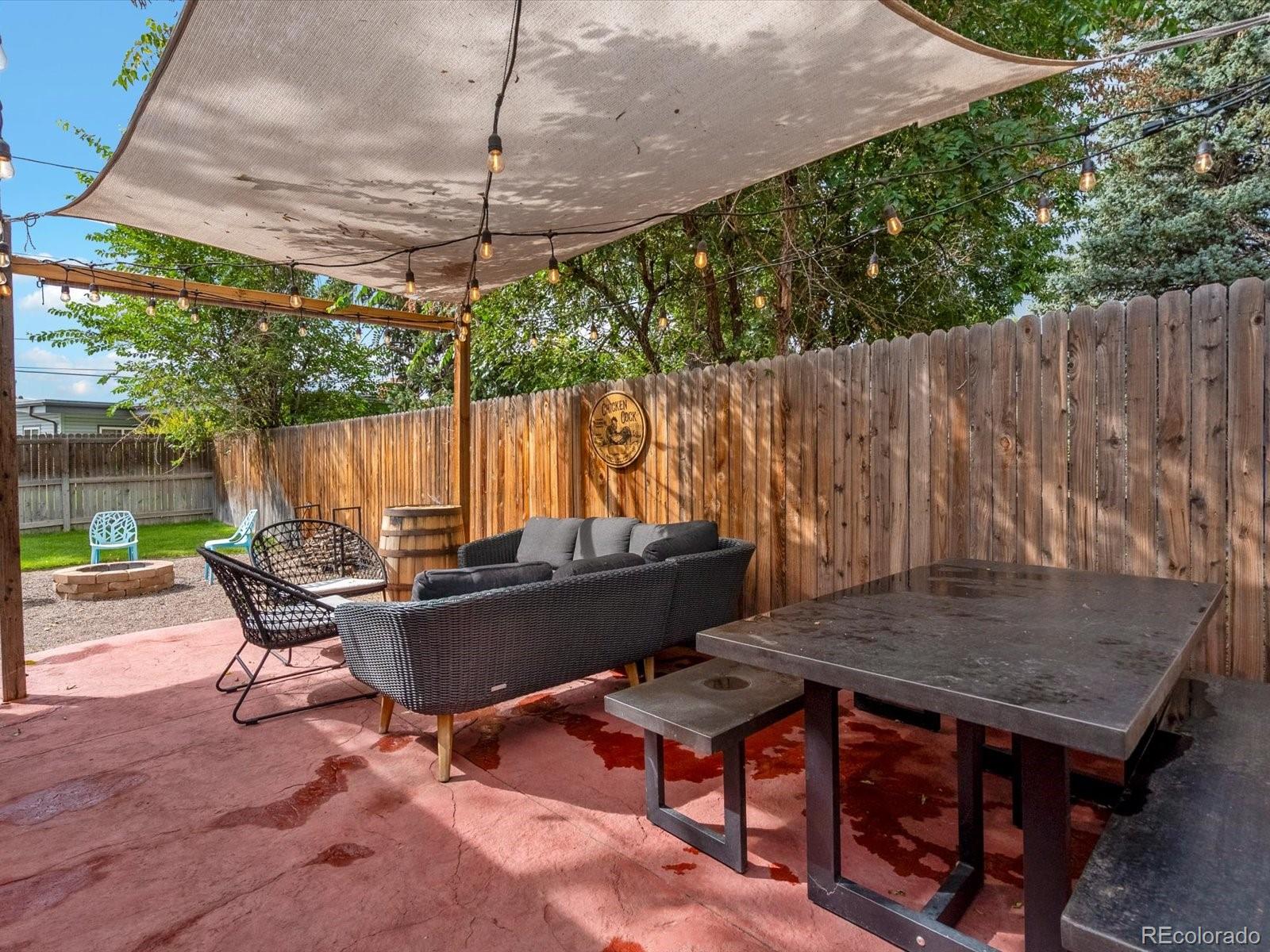 4963 North Harlan Street Wheat Ridge, CO 80033 - Photo 35 of 42 a backyard of a house with table and chairs