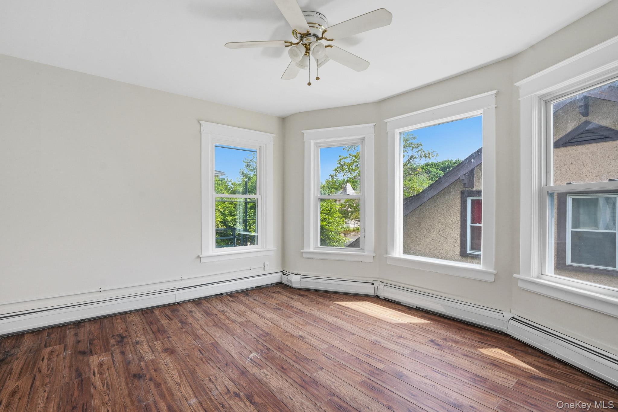 65 North Clinton Street Poughkeepsie, NY 12601 - Photo 33 of 43 an empty room with wooden floor fan and windows