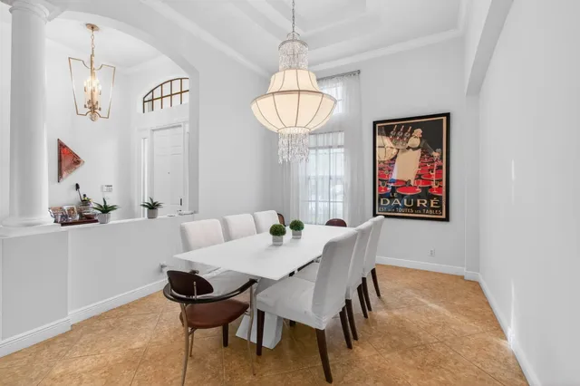 a view of a hallway with wooden floor and a bathroom