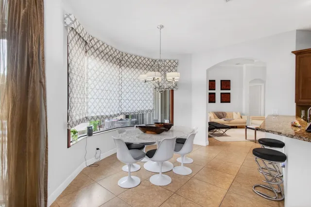 a dining room with furniture and garden view