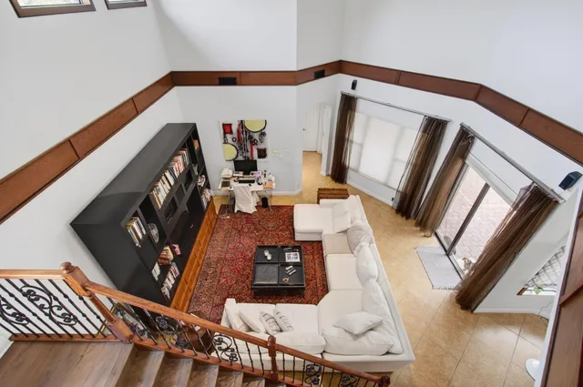 a living room with furniture a flat screen tv and a table