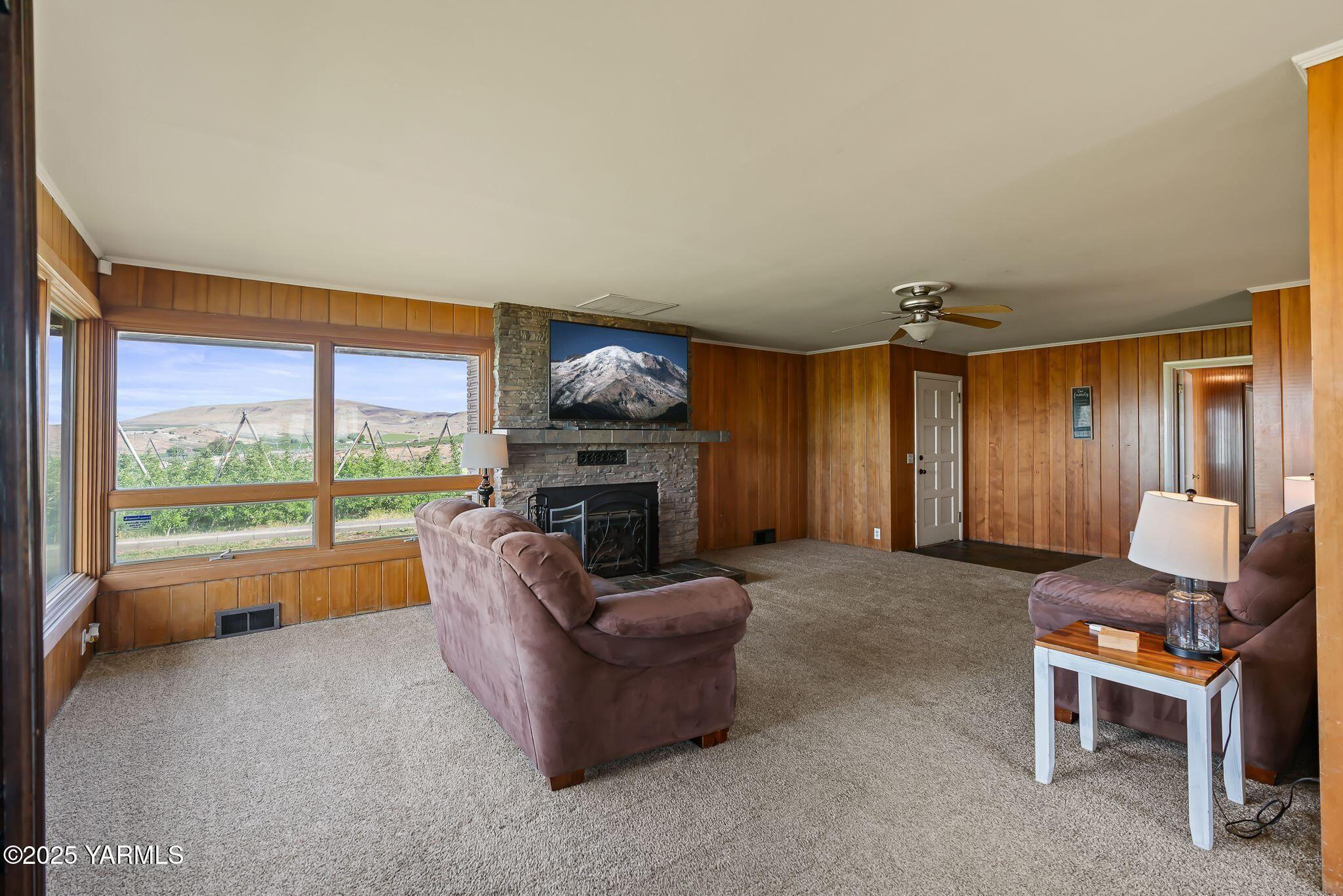 3090 Lombard Loop Road Wapato, WA 98951 - Photo 8 of 44 a living room with furniture a fireplace and a large window