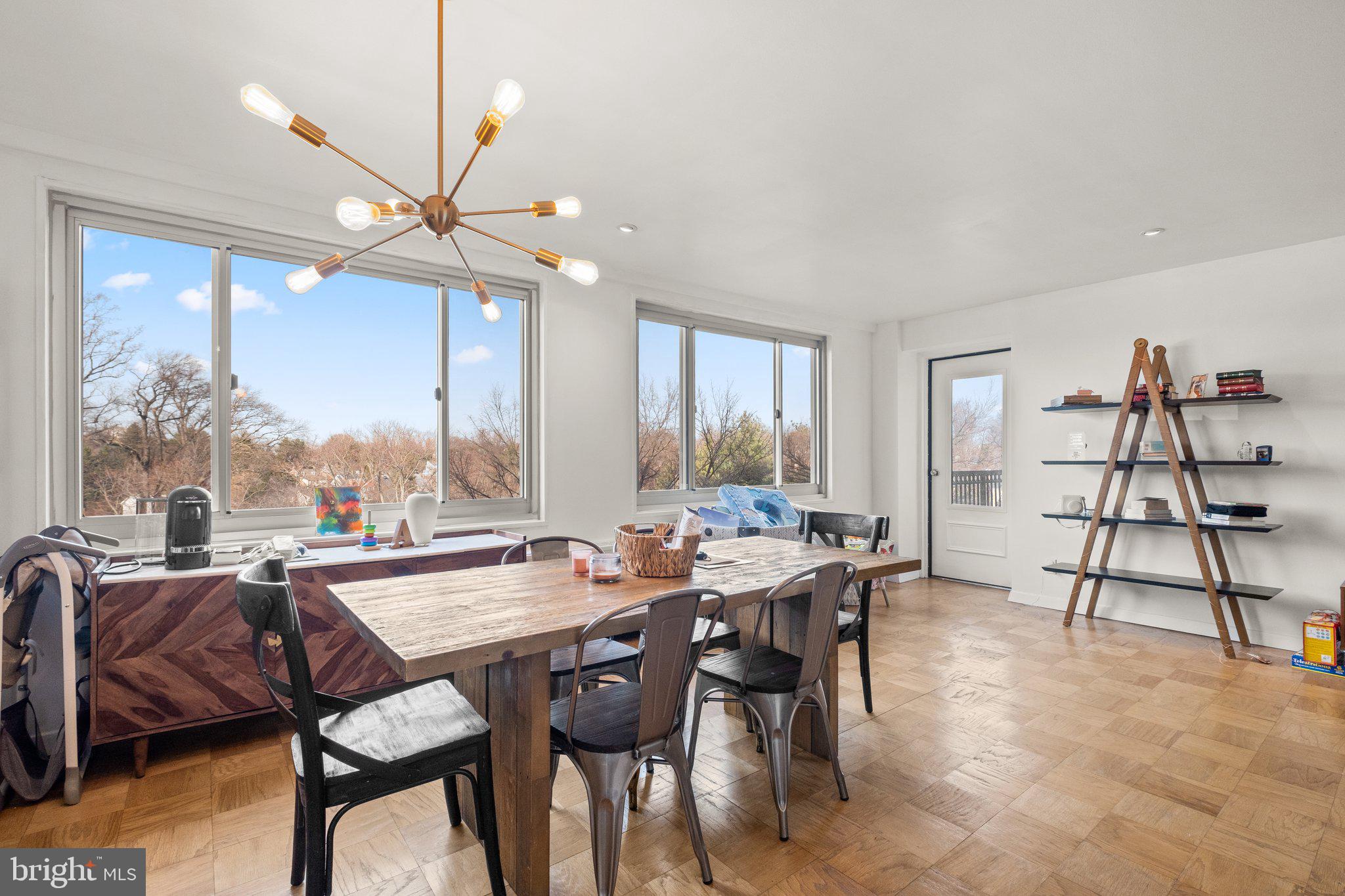 1900 Lyttonsville Road, Unit 1016 Silver Spring, MD 20910 - Photo 1 of 30 a view of a dining room with furniture window and wooden floor