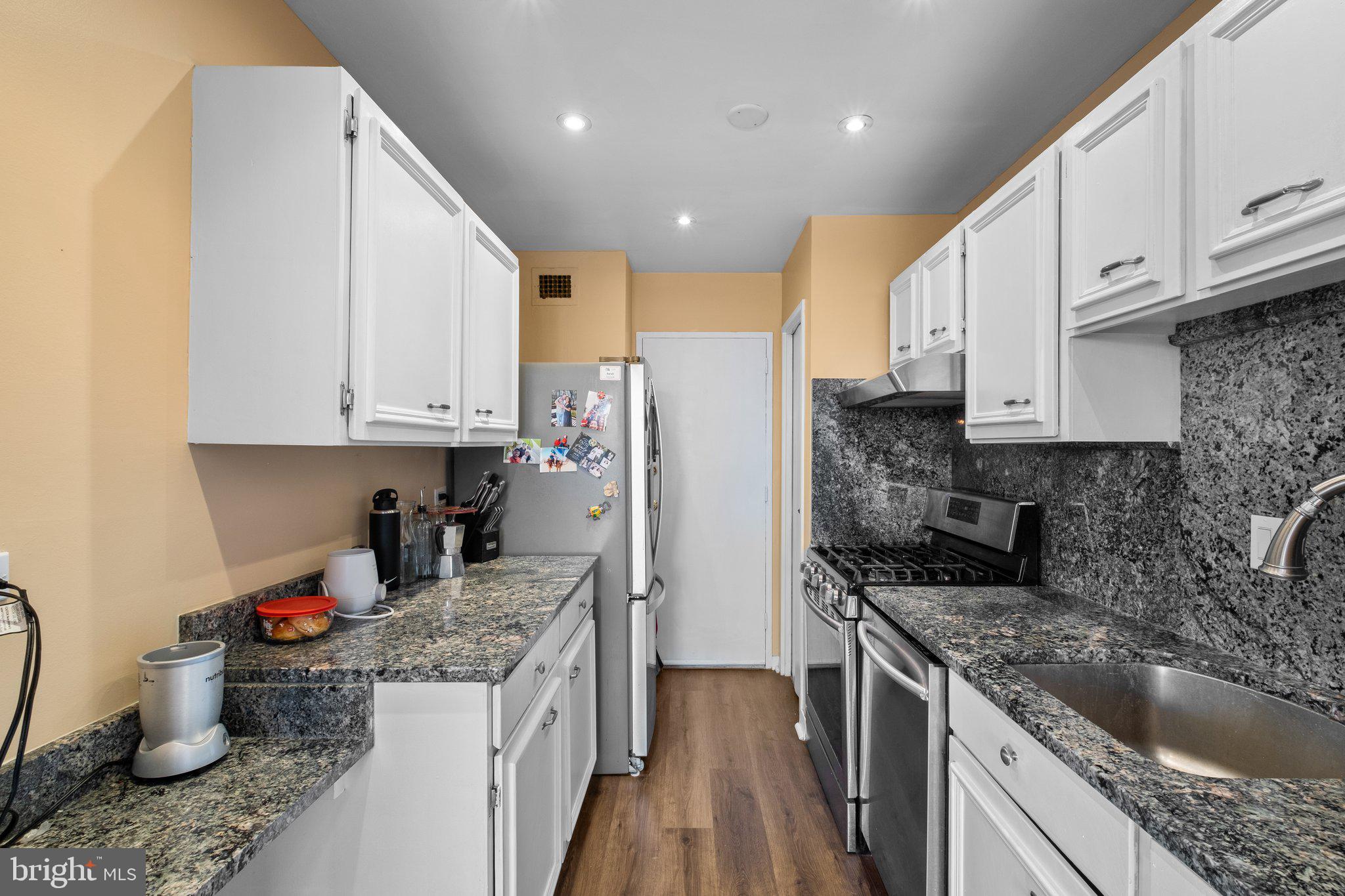 1900 Lyttonsville Road, Unit 1016 Silver Spring, MD 20910 - Photo 11 of 30 a kitchen with a sink stove and cabinets