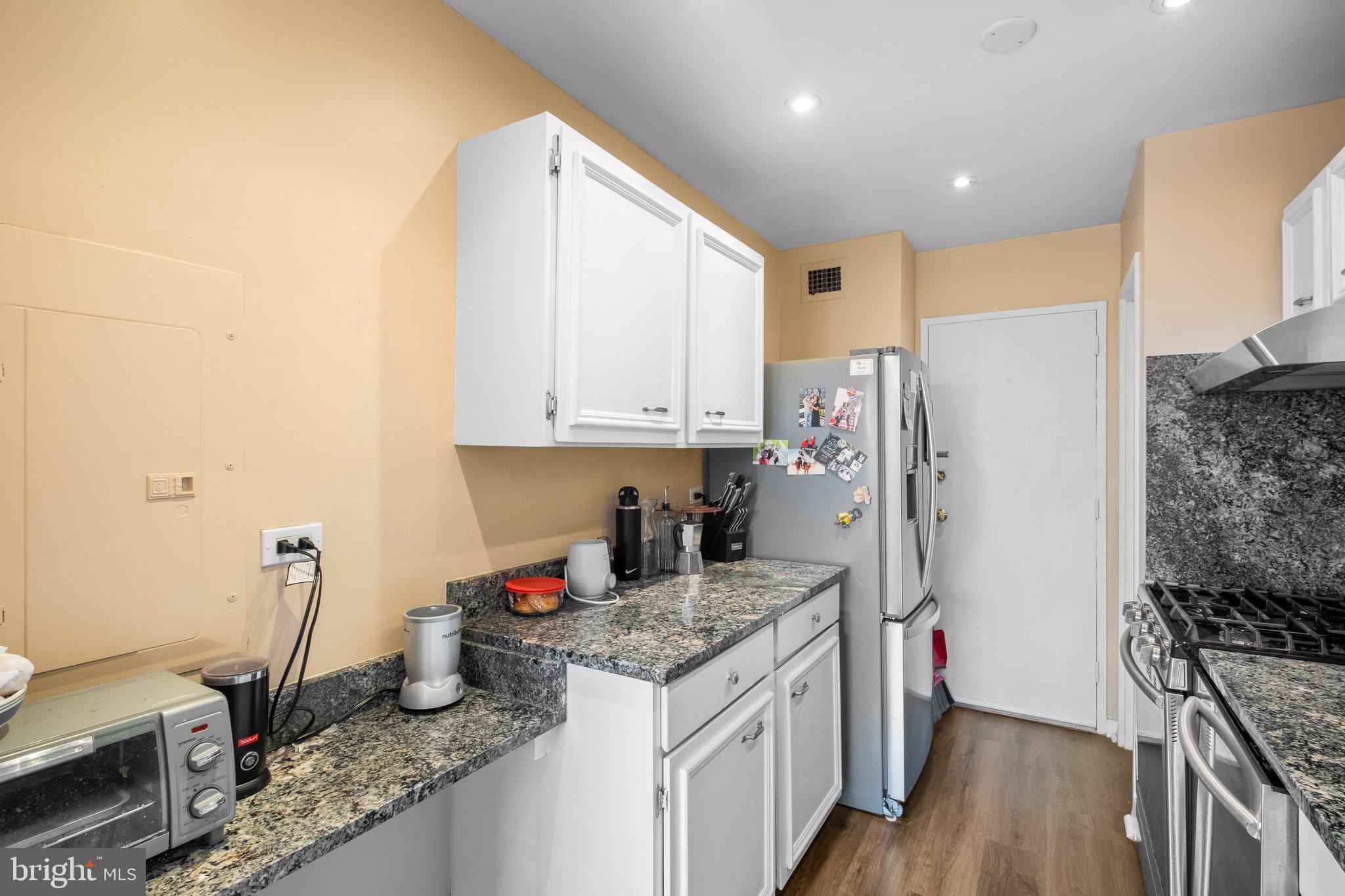 1900 Lyttonsville Road, Unit 1016 Silver Spring, MD 20910 - Photo 13 of 30 a kitchen with stainless steel appliances granite countertop a stove and a refrigerator