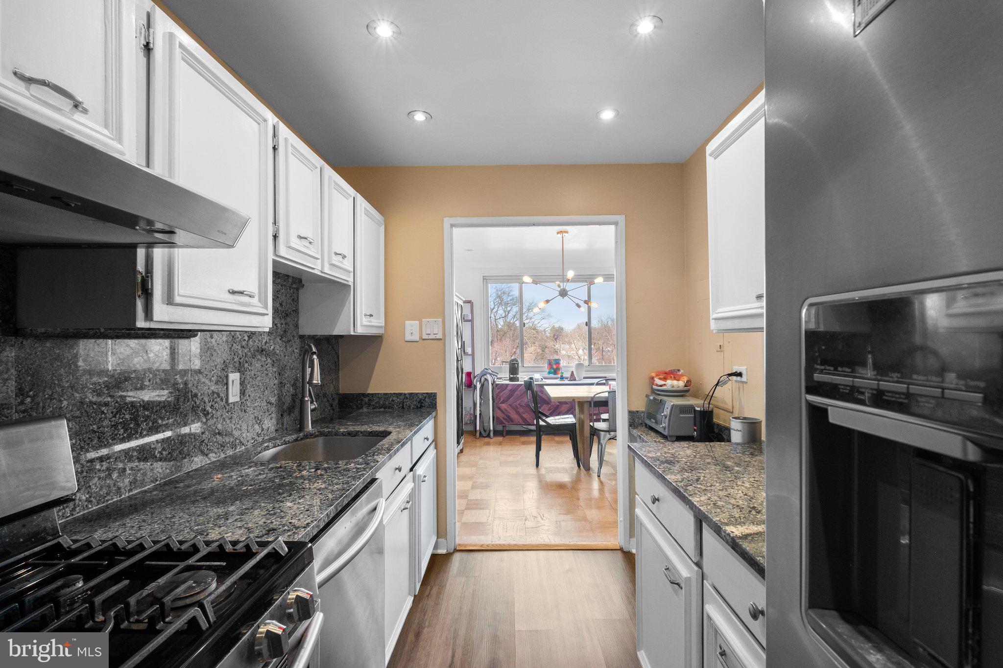 1900 Lyttonsville Road, Unit 1016 Silver Spring, MD 20910 - Photo 15 of 30 a kitchen with a stove and a white cabinets