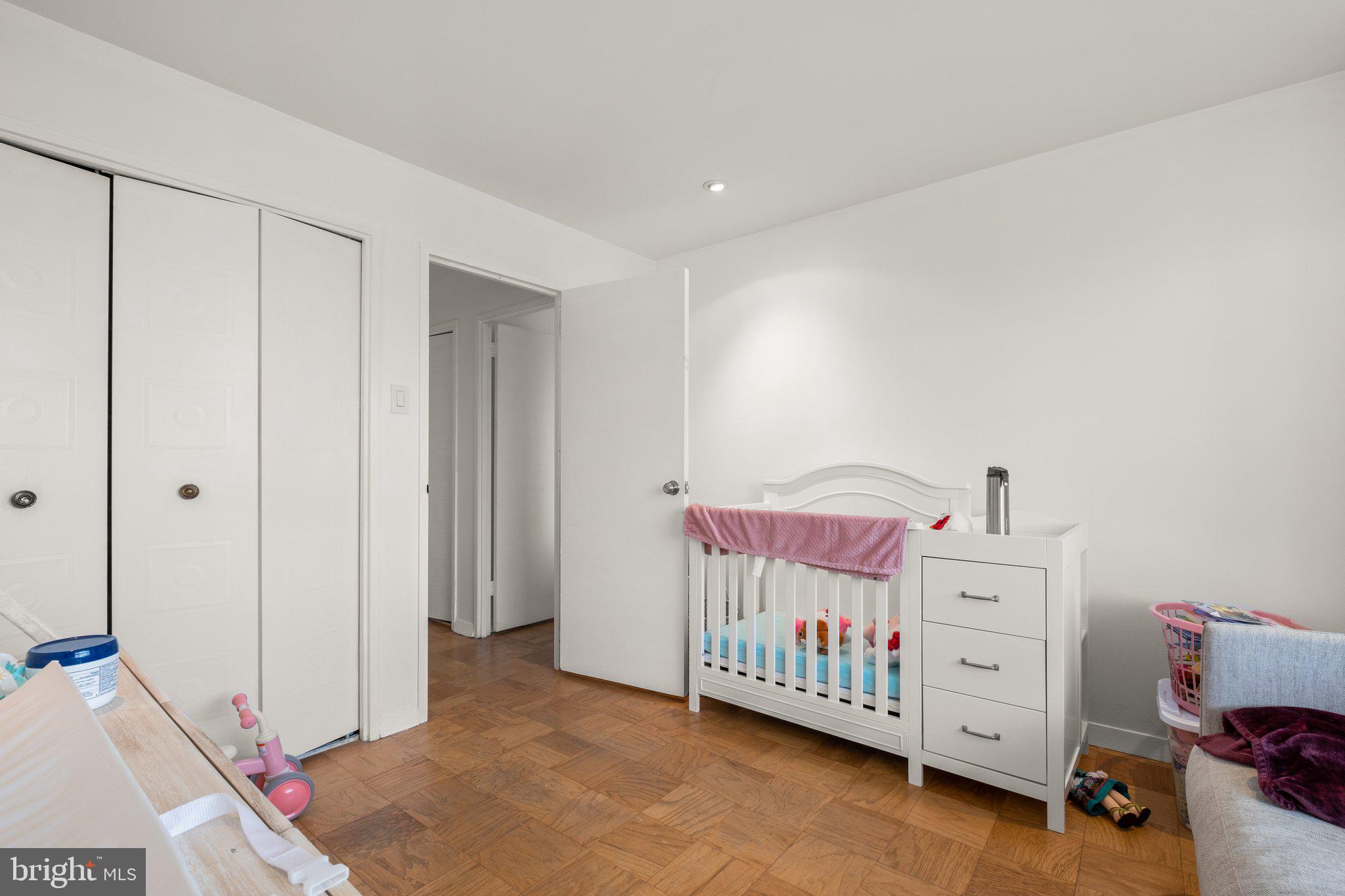 1900 Lyttonsville Road, Unit 1016 Silver Spring, MD 20910 - Photo 26 of 30 a bedroom with furniture and a baby crib