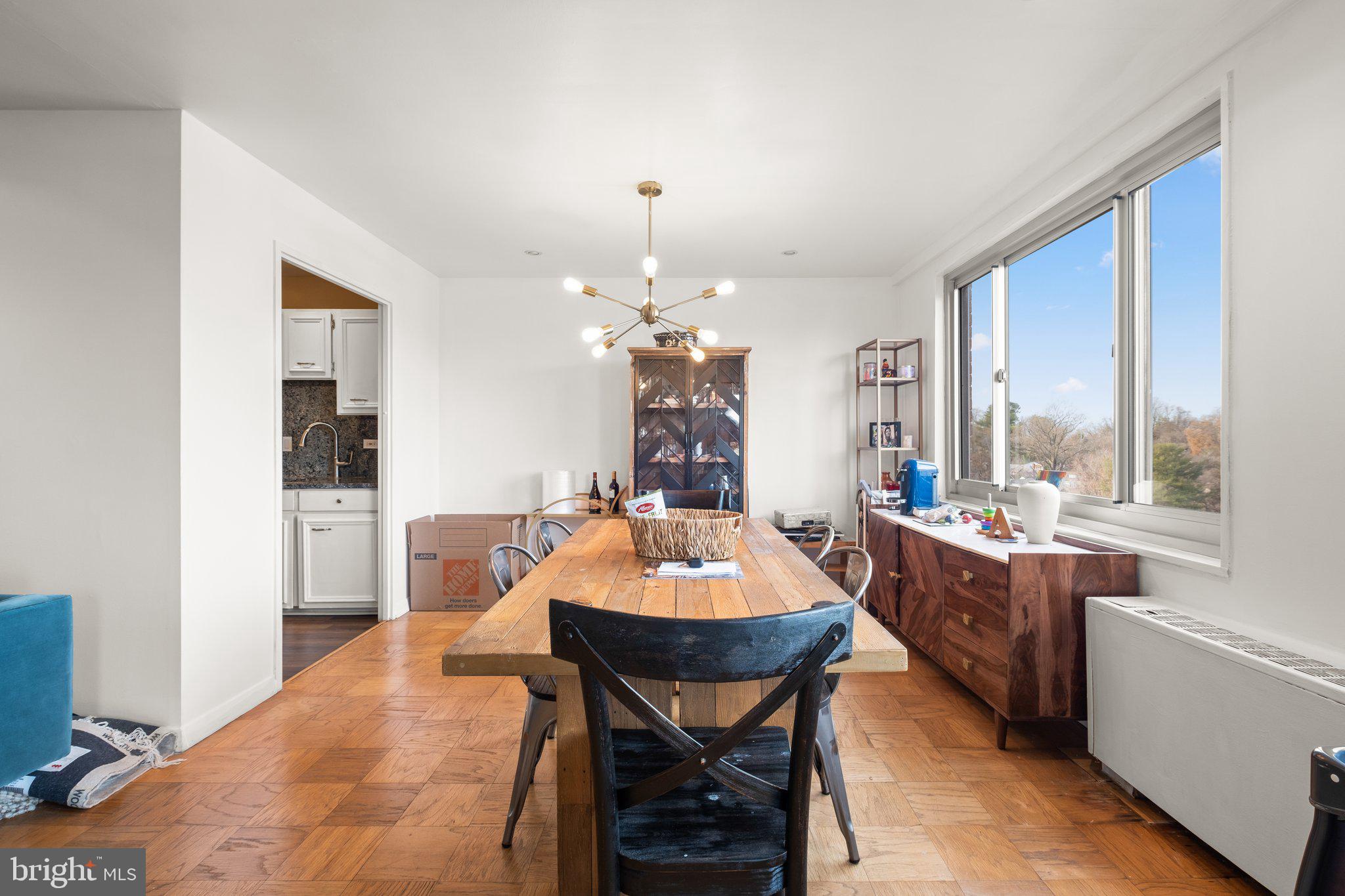 1900 Lyttonsville Road, Unit 1016 Silver Spring, MD 20910 - Photo 7 of 30 a dining room with a table and chairs