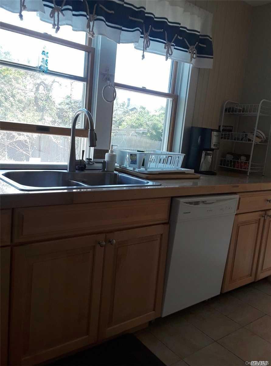 49 Surf Ocean Beach, NY 11770 - Photo 3 of 12 a kitchen with a sink and large window