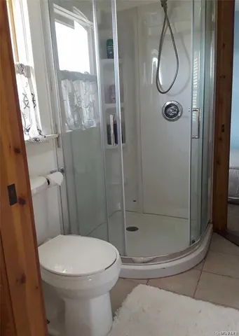 a bathroom with a toilet and a shower