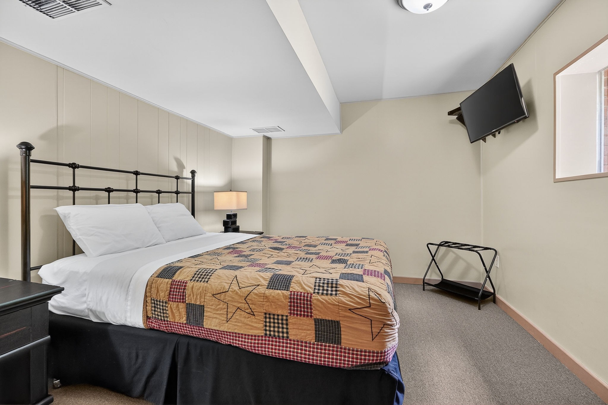 5642 Pates Ford Road Smithville, TN 37166 - Photo 24 of 32 a bedroom with a bed and flat screen tv