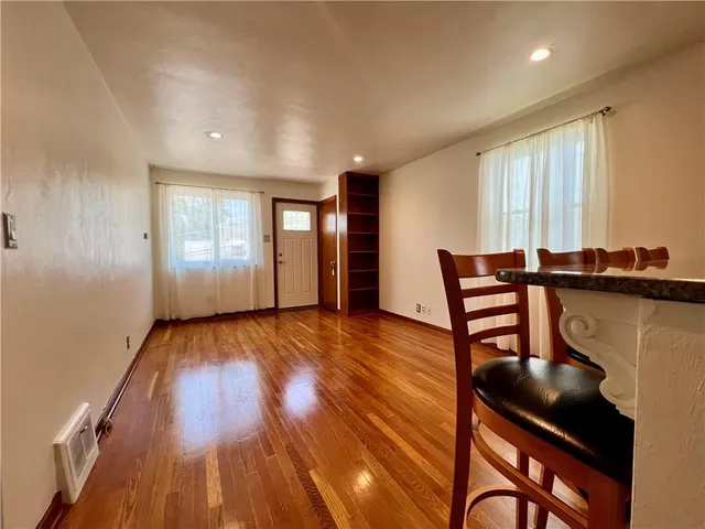 a view of room with hardwood floor and a ceiling fan