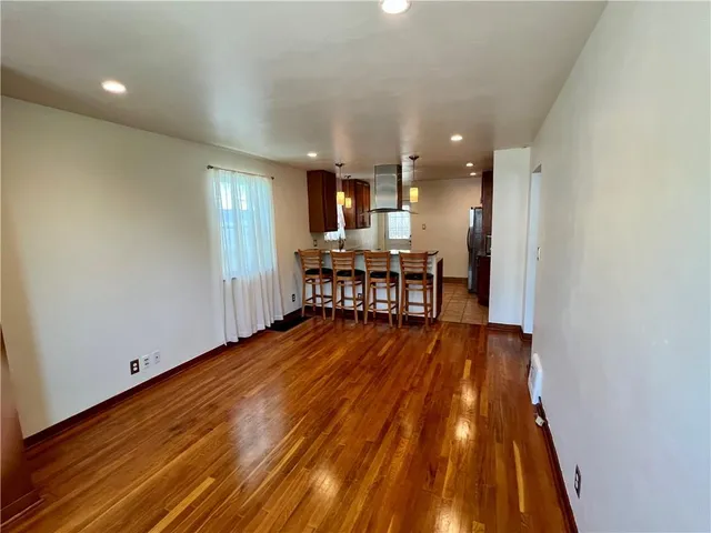 a view of a kitchen with workspace and wooden floor