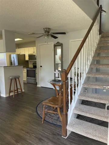 a view of entryway and hall with wooden floor