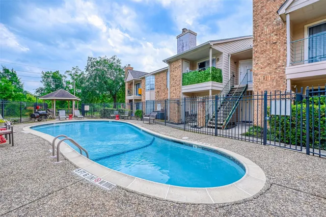 a view of a house with swimming pool and sitting area