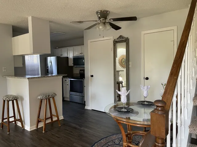 a kitchen with stainless steel appliances granite countertop a refrigerator and a stove top oven