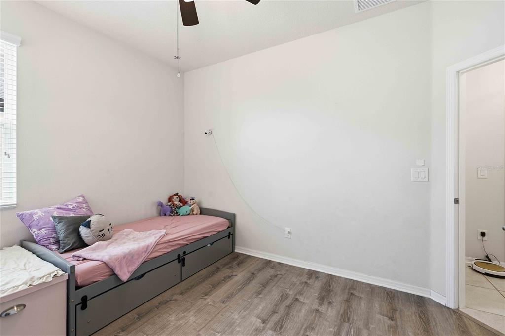 10920 79th Street East Parrish, FL 34219 - Photo 22 of 73 a room with a bed and chandelier