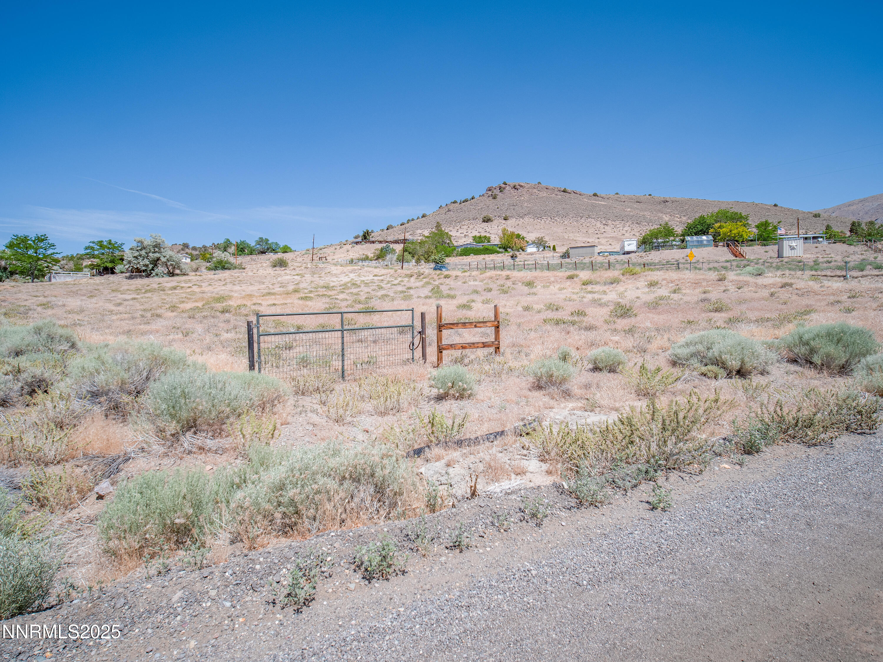 3955 Mica Court Topaz Ranch Estates, NV 89444 - Photo 5 of 26 a view of a dry yard with wooden fence