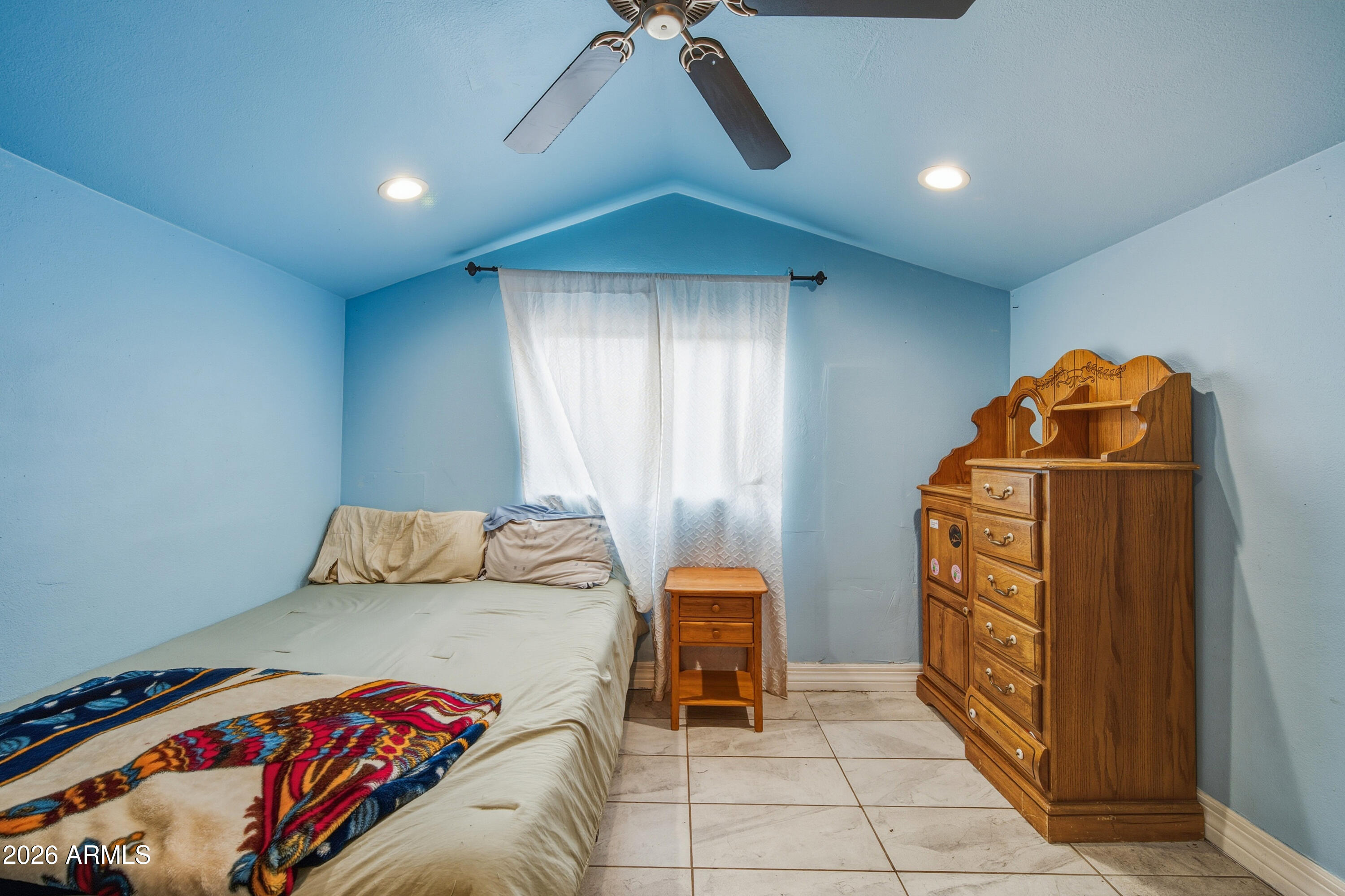 2726 West Taylor Street Phoenix, AZ 85009 - Photo 10 of 17 a bedroom with a bed and a cabinets