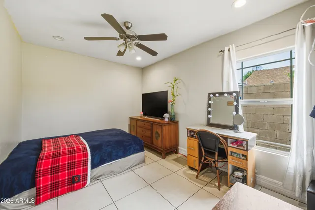 a bedroom with a bed and a television