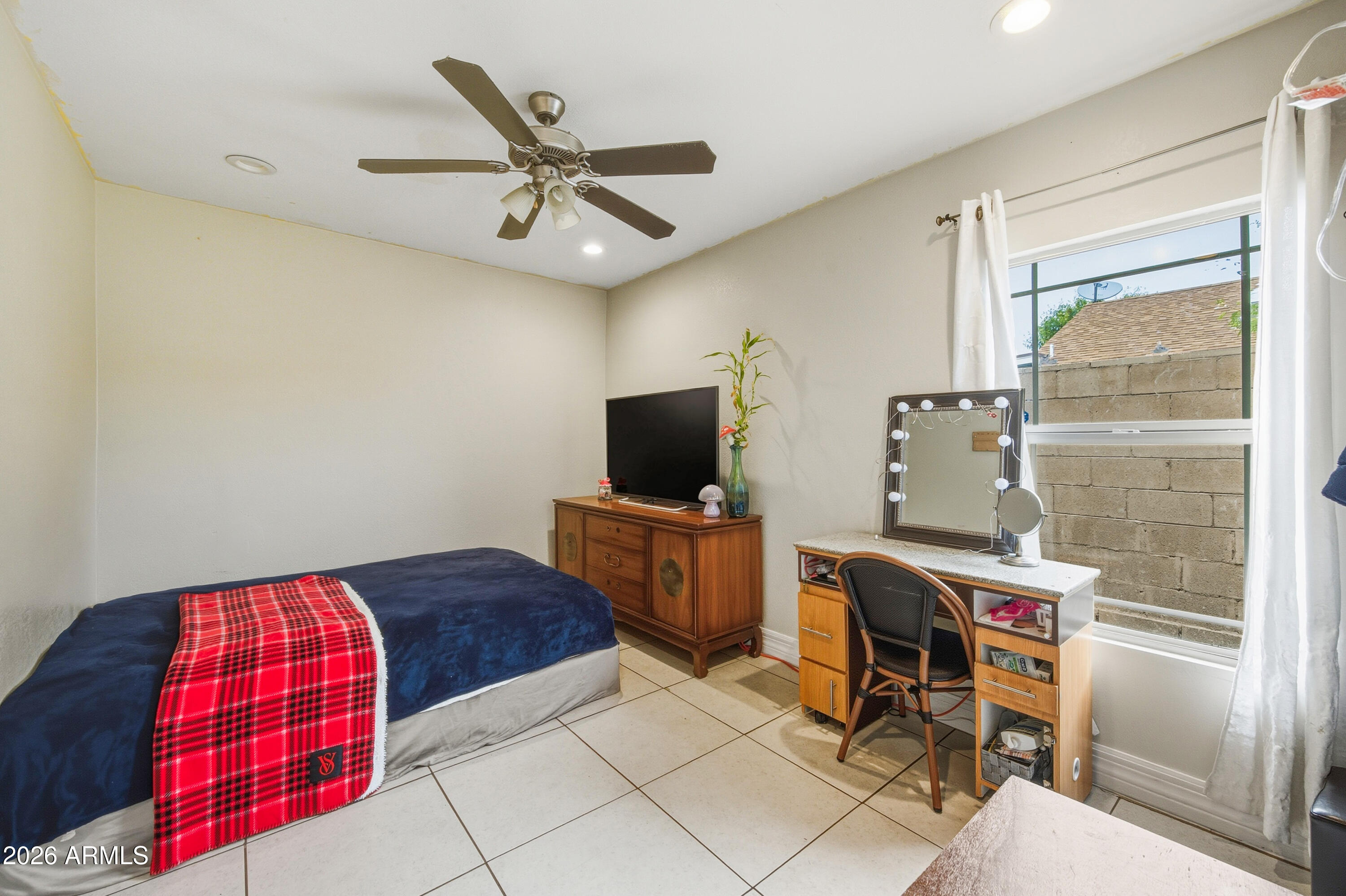 2726 West Taylor Street Phoenix, AZ 85009 - Photo 11 of 17 a bedroom with a bed and a television