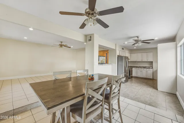 a dining room with furniture and a chandelier