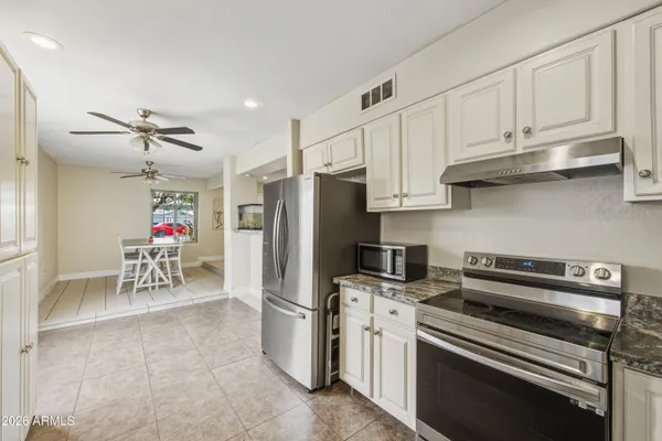 a kitchen with refrigerator cabinets and a sink