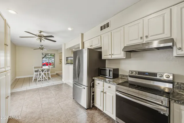 a kitchen with refrigerator cabinets and a sink