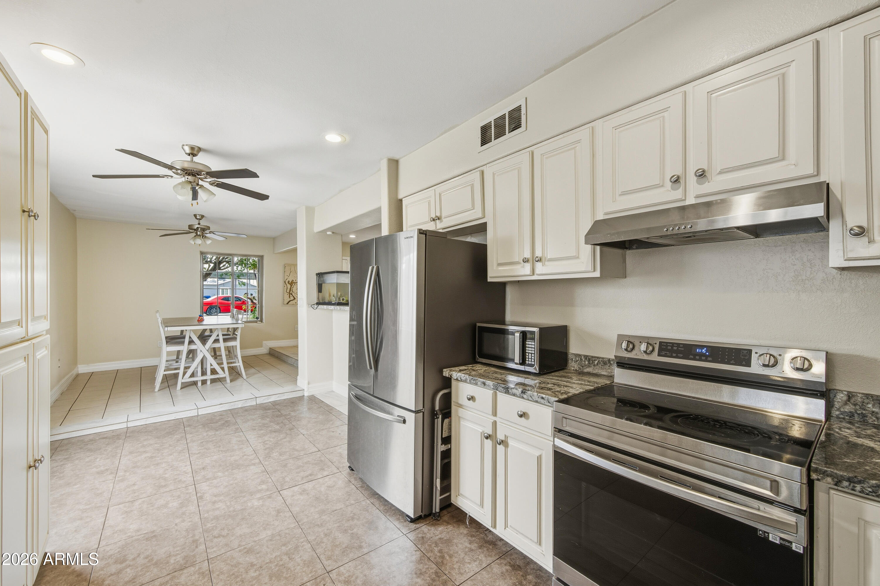 2726 West Taylor Street Phoenix, AZ 85009 - Photo 9 of 17 a kitchen with refrigerator cabinets and a sink