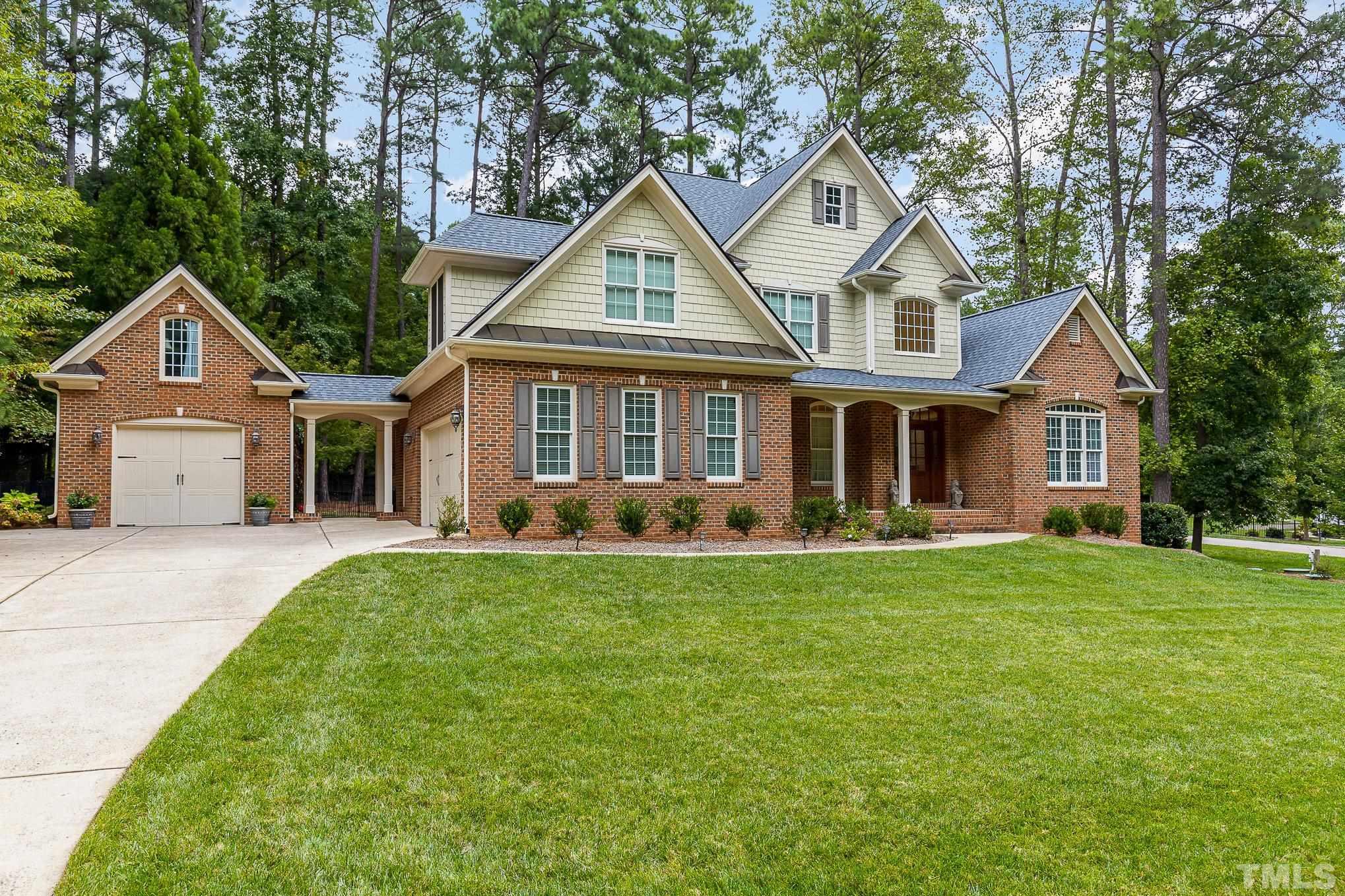 1820 Bowling Green Trail Raleigh, NC 27613 - Photo 1 of 48 a front view of a house with a garden and porch