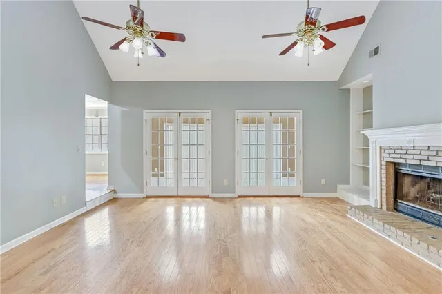 a view of livingroom with window fireplace and wooden floor